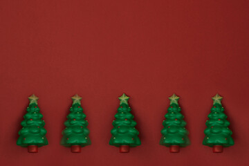 Toy tree red background. New Year's decor. Copy space, mock up