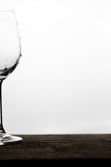 A part of a wet wine glass on a white background