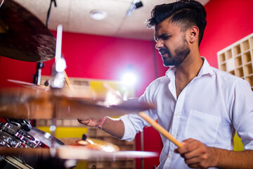 italian artist musician playing drumms during online concert at studio