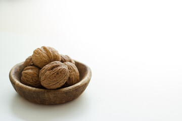 Whole walnuts in a wooden bowl