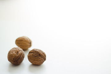 Close up of three walnuts on white background; isolated