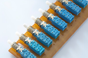 Set of old electric switches and buttons isolated on white background. Blue mechanic push with...