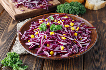 Sliced red cabbage salad with corn. Healthy food.