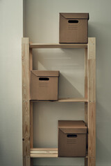 Paper boxes are on a wooden rack. Archive storage, use of eco-friendly materials