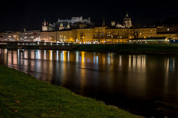Fototapeta na wymiar city of salzburg with castle at night at river salzach