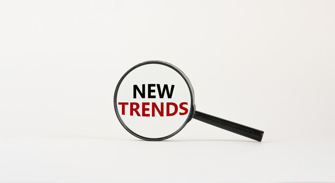 Time for new trends. Magnifying glass with words 'new trends' on beautiful white background. Business and new trends concept, copy space.