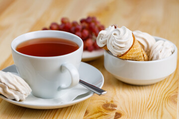 Tea mug with cake on Christmas holiday table selective focus background blurred.