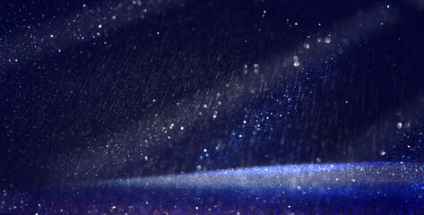 background of abstract glitter lights. Purple, silver, blue and black. de focused