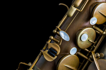 Fototapeta premium Vintage saxophone on a black background