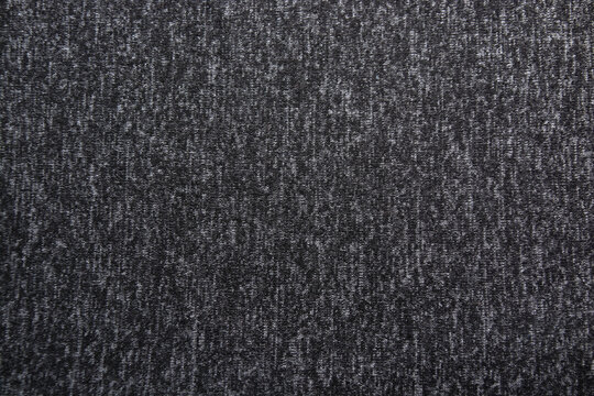 gradient dark gray background with textile texture. © евгений ставников