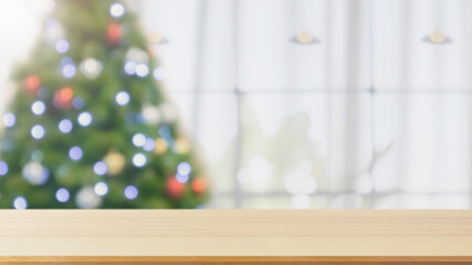 Empty table top with blurred Christmas tree with bokeh light background