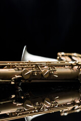 Vintage saxophone on a reflective surface