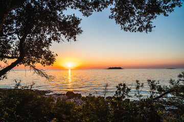 Fototapeta na wymiar Beautiful dramatic sunset over the Adriatic Sea in Croatia. Relaxing tranquil peaceful place by the sea, touristic destination in Europe