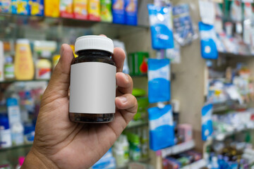 hand holding bottle of medicine