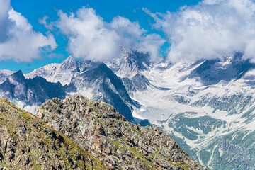 Obraz premium Colorful and bright landscape of mountains and white clouds. Dangerous mountainous terrain.
