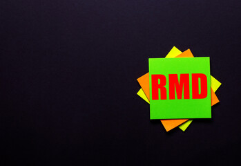 The word RMD on a bright sticker on a dark background