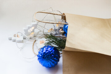 in a paper bag Christmas blue balls from the store on a white background