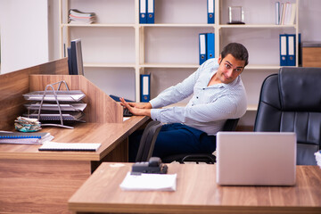 Young male employee working in the office