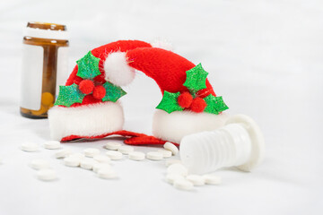 Medicine concept christmas new year during covid-19 coronavirus. Pills and Christmas decorations on a light background