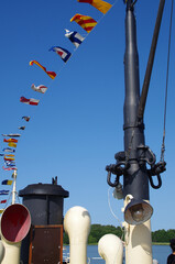 blue sky, old steamer and flags