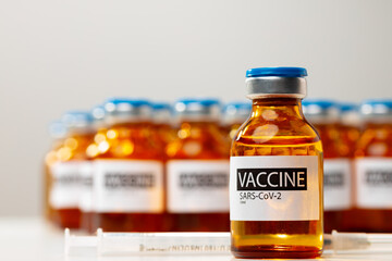 Sars-cov-2 vaccine vial bottles on white table