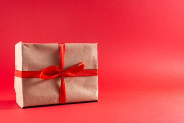 Light brown cardboard boxes with red ribbon and bows Christmas gifts. 