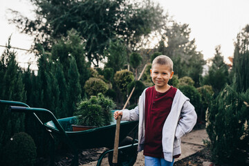 grandson with his grandfather working in plant nursery