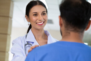 smiling female doctor helping support and reassuring patient after cancer surgical treatment recovery. medical and healthcare concept.