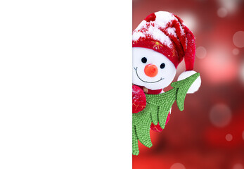 Little snowman in cap with Christmas tree on snow in the winter. Background with a funny snowman....