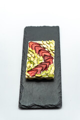 Chocolate bar with the addition of fruit nuts on background. Dessert food concept.