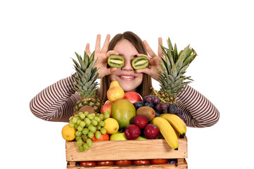 happy girl holding kiwi in front of her eyes