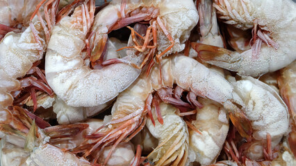 A background full of frozen shrimps, close up.