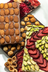 Chocolate bar with the addition of fruit nuts on background. Dessert food concept.