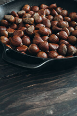 chestnut on dark wooden table
