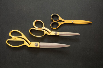 Scissors set gold on black background, top view