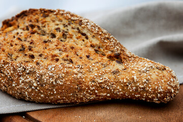 Dark cereal bread on a wooden board. Close-up.