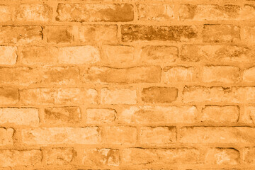 Brick orange colorful wall surface texture. Abstract grunge bright marigold color background with aging effect. Copyspace. Trendy color of the year 2021.