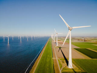 Windmill park in the Netherlands ocean, Windmill farm with huge turbines green energy in the...