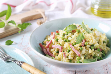 Italian Cuisine. Stortini pasta with green peas and bacon