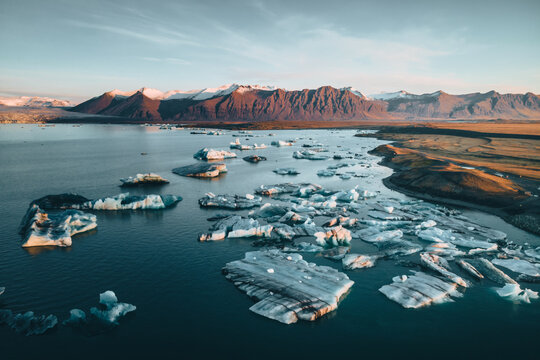 High quality aerial photo of the glacial lagoon Jokulsarlon in Iceland with the huge icebergs and mountains in the background. Climate change high resolution photo