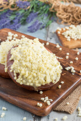 Turkish pogaca / pastry covered with cheddar cheese on a wooden table.