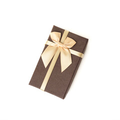 Brown craft gift box with satin beige ribbon bow isolated on white background.