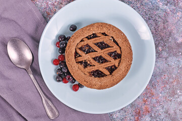 Small homemade tartlet called 'Linzertorte', a traditional Austrian shortcake pastry topped with...