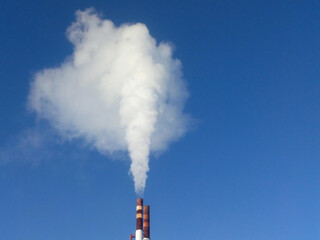 White smoke from the chimney against the blue sky