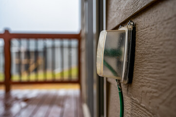 Outdoor covered GCFI outlet with power cord in use