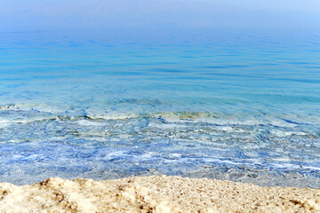 Texture of Dead Sea. Salty sea shore background. Salt accumulation on the Dead Sea shore in Jordan