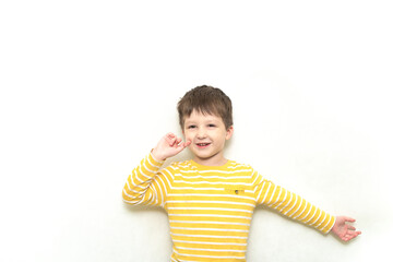 Happy Cute toddler boy caucasian in striped shirt with funny expression.