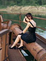 Beautiful girl in a fashionable little stylish black dress. Fashion, beauty and style.