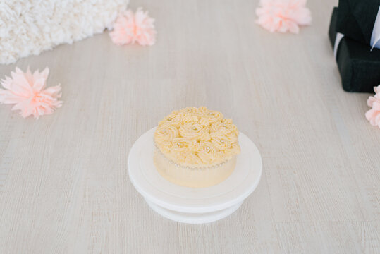 Sweet delicious birthday or holiday cake, decorated with rose-shaped cream.