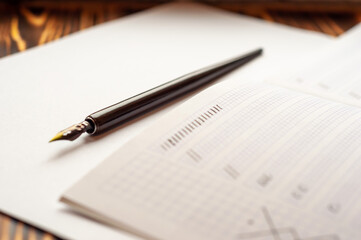 Fototapeta premium Fountain pen and notebook on the table.